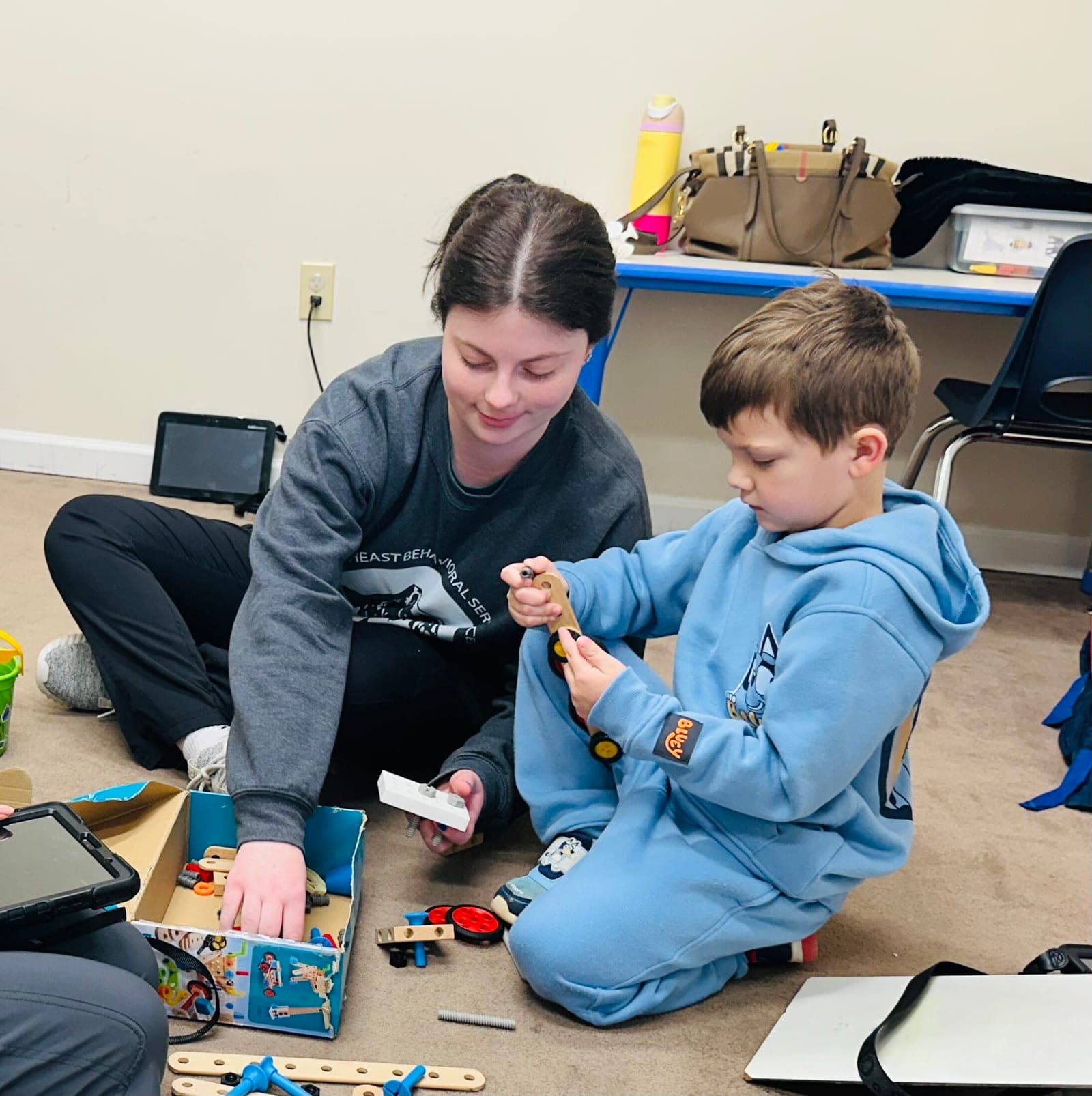 A SEBS team member working with a child during a therapy session