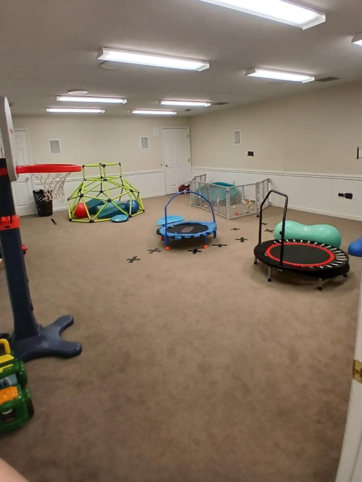 Indoor gym with trampolines and climbing dome at the SEBS Morristown clinic
